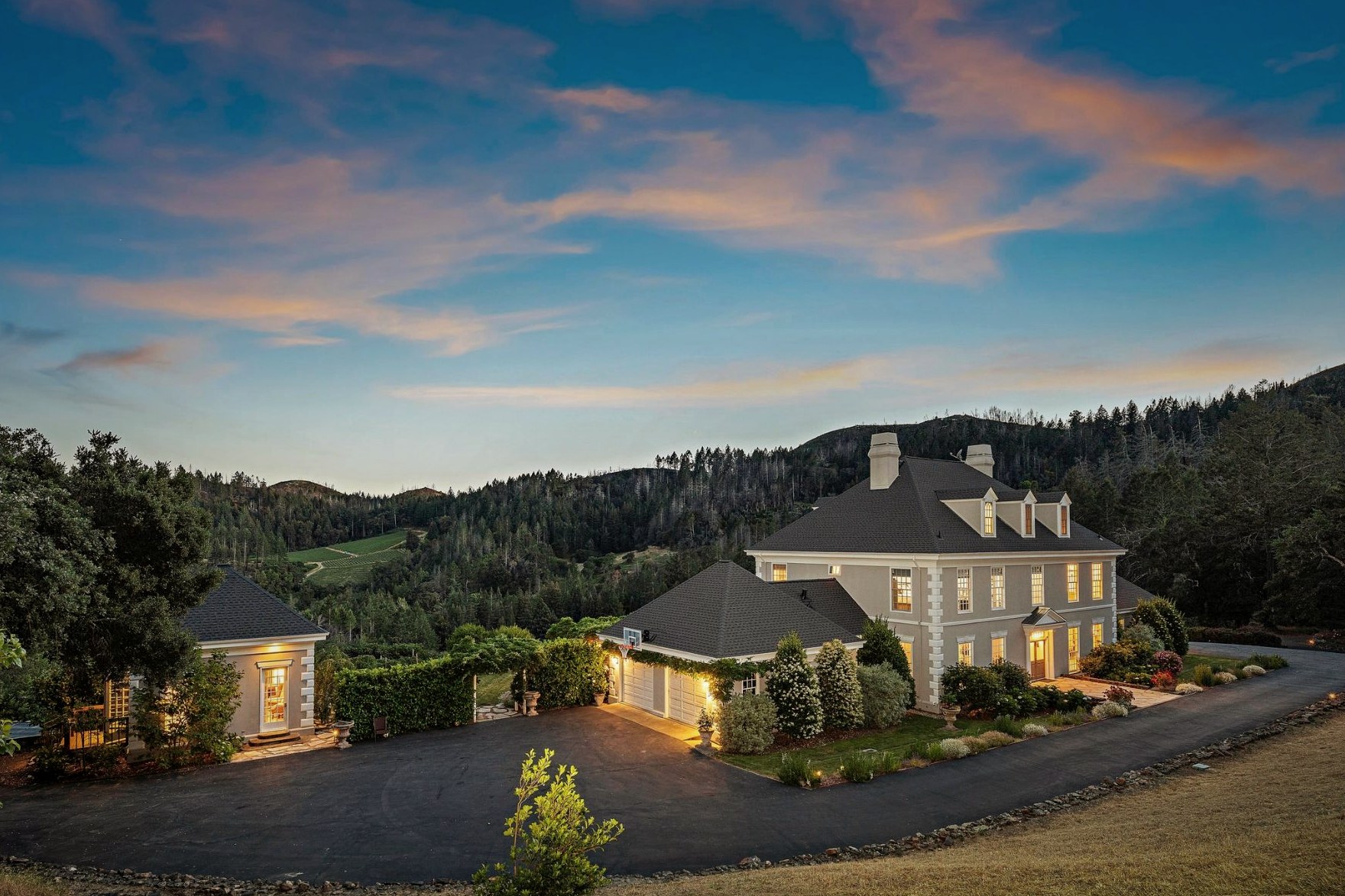 The estate at sunset, with hillside and Napa sky beyond