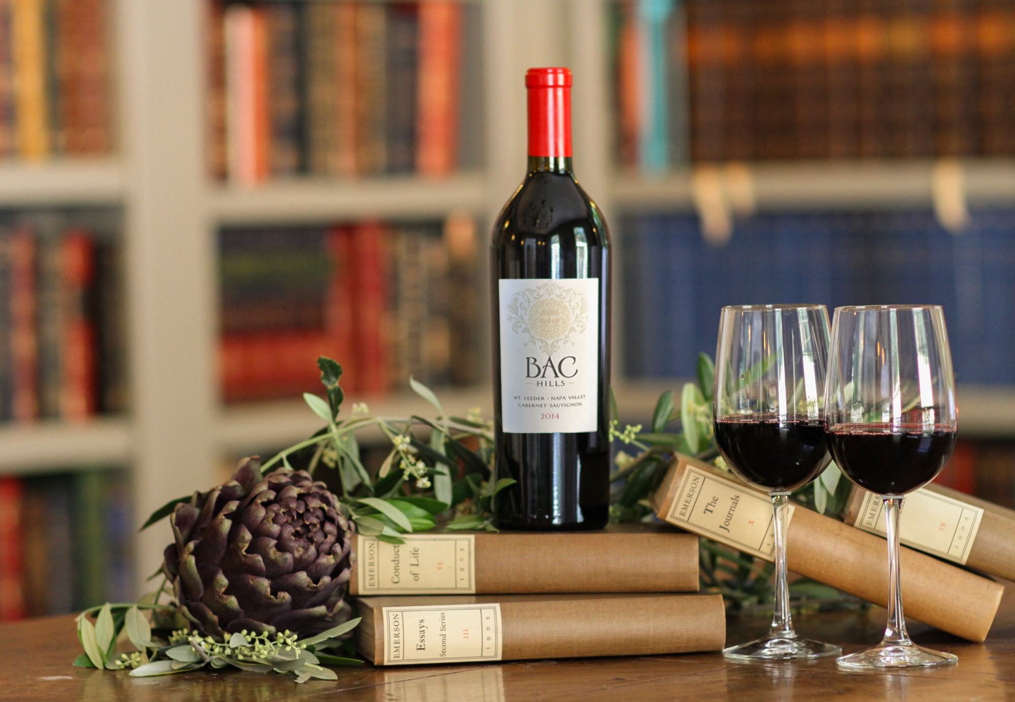 Bac Hills 2014 bottle on Emerson volumes with poured glasses, library setting